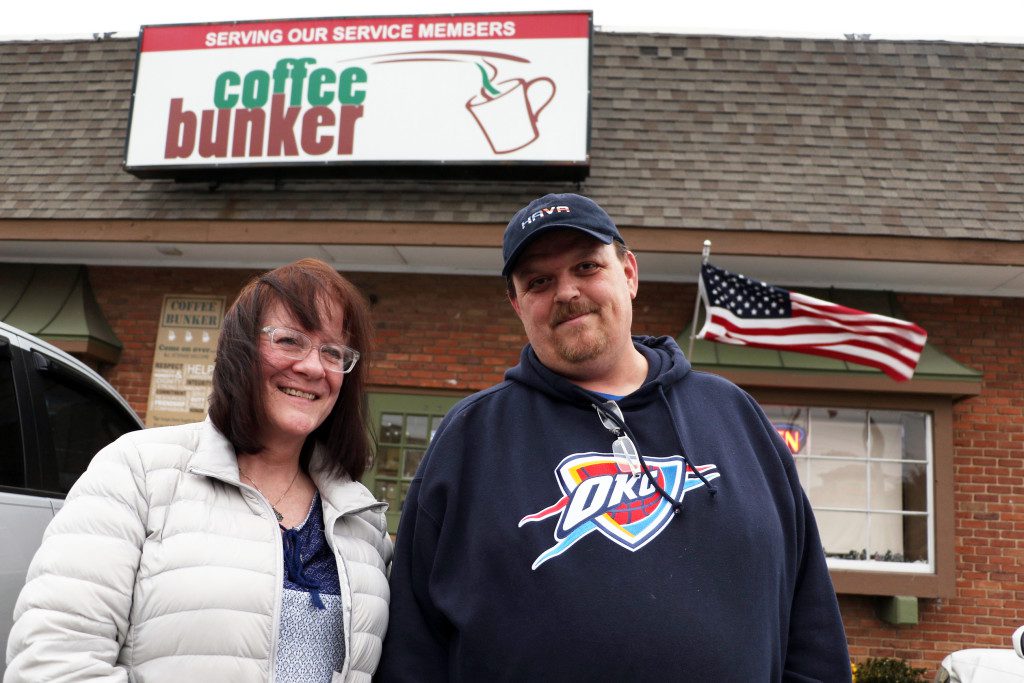 Mary Ligon, left, and Scott Blackburn pose outside of the Coffee Bunker. Ligon founded the Coffee Bunker after her son, Daniel, committed suicide upon returning from the Iraq War. DYLAN GOFORTH/The Frontier