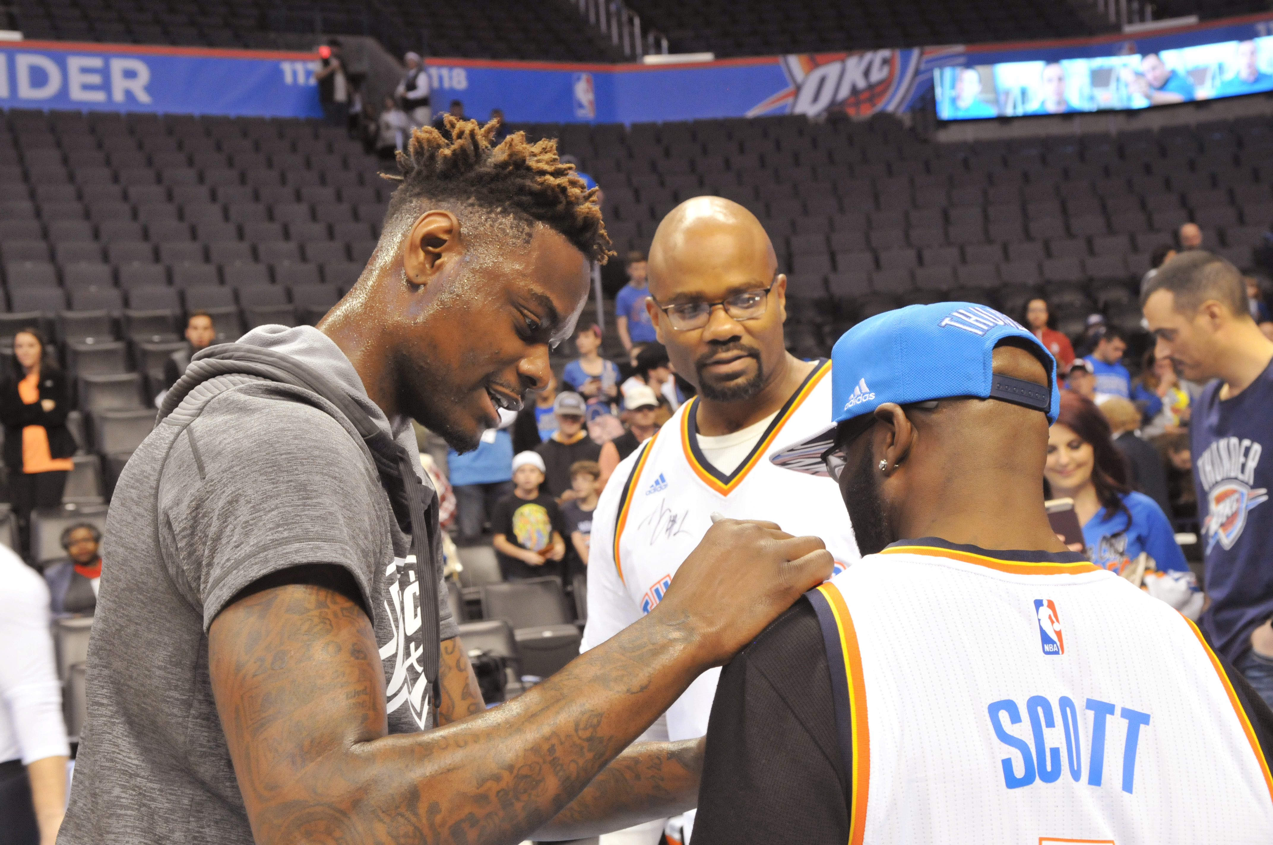 The Thunder's Anthony Morrow signs Malcolm Scott's jersey. Photo by Michael Downes